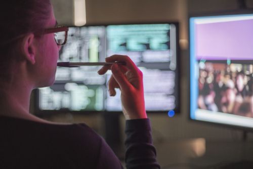 Young woman monitoring computer usage, illustrating workplace privacy concerns and employer monitoring of emails and online activity in Connecticut.