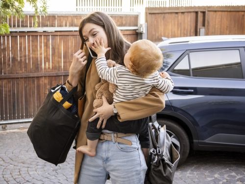 Mother with young son, trying to balance home and work life. Visual concept for a blog discussing FMLA Leave.