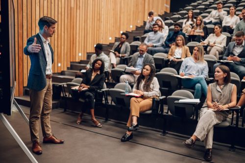 College professor in a classroom setting with students. Higher education lawyers for faculty specialize in legal protections for college professors facing retaliation.